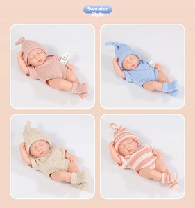 Detailed view of four reborn baby dolls in various knitwear styles and colors