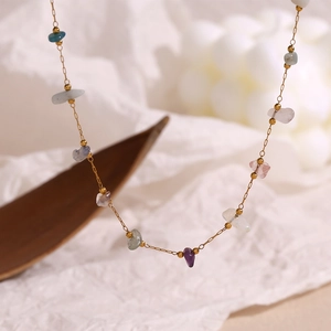 Macro shot of 18K gold plated necklace featuring colorful natural crushed stones