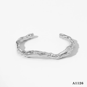 Minimalist 316 stainless steel open bangle with organic irregular textured surface