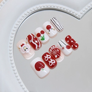 Detailed view of Christmas press-on nails with snowman, snowflakes, and festive patterns