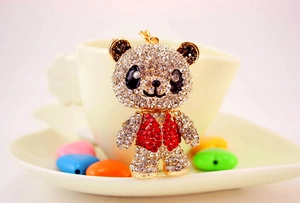 Detailed view of panda keychain with sparkling red vest and crystal rhinestones