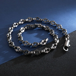 Detailed view of heavy stainless steel geometric chain with a vintage textured finish