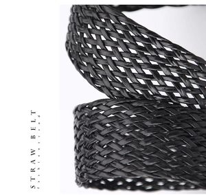Detail shot of the black straw woven texture on a fashion belt for women