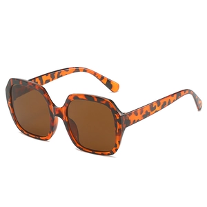 Oversized geometric sunglasses with tortoiseshell frames and brown lenses for women