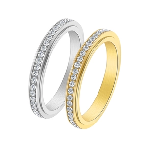 Macro detail of spinning stainless steel rings with gold finish and full crystal inlay