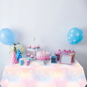 Pink and blue gradient rainbow tablecloth setup for a girl's birthday party celebration