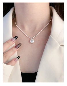 Elegantly worn S925 sterling silver necklace featuring a large white baroque pearl pendant