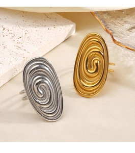 Macro detail of gold and silver chunky oval rings with spiral texture and open band