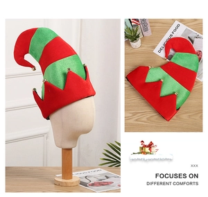 Close-up of red and green striped Christmas elf hat with golden bell and jagged trim