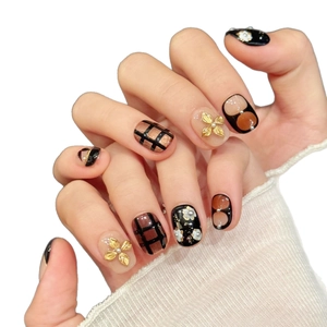 Vintage black and gold press-on nails with 3D floral carvings and elegant pearl accents