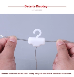 Detail of white plastic hanging hooks on transparent LED icicle string light cables