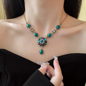 Close-up of vintage flower necklace with colorful crystals on a model's neck