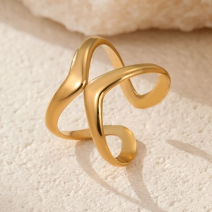 Macro shot of 18k gold plated double wave ring on a textured stone surface