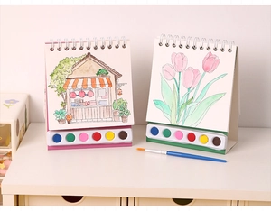 Vertical view of portable watercolor book set with 6-color paint palette and blue brush