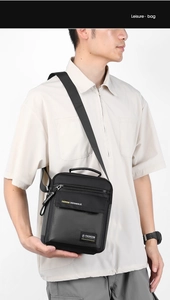 Detail of black nylon crossbody bag featuring front zip pocket and stylish leisure label
