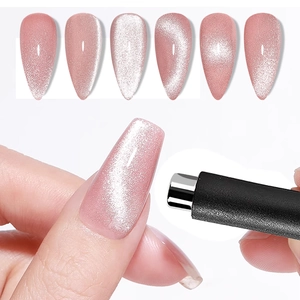 Cylindrical nail magnet tool showing cat-eye effect on various pink glitter nail tips