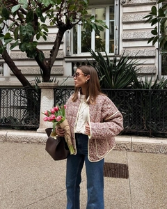 Close-up of floral quilted jacket with yellow piping and retro French lifestyle aesthetic