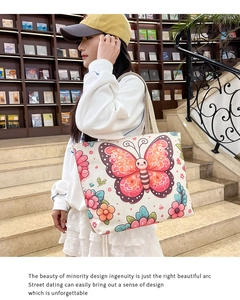 Detailed shot of ethnic print canvas tote bag with butterfly motifs and braided strap