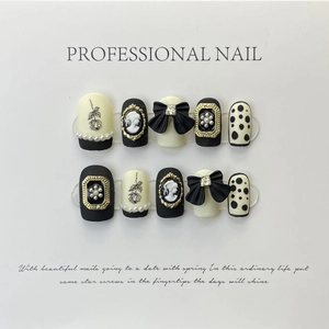 Vintage style black and white press-on nails with rose, cameo and bow designs