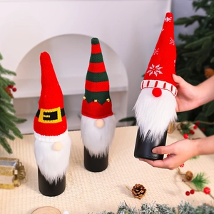 Detailed view of handmade knitted Christmas gnome wine bottle covers with faux fur beards