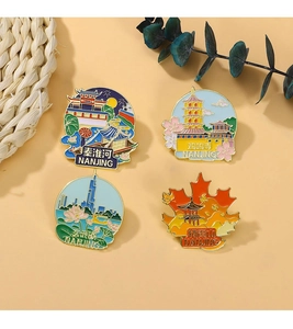 Flat lay of Nanjing landmark metal badges with colorful enamel scenes on straw mats
