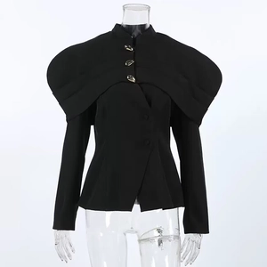 Close-up of black women's blazer featuring gold decorative buttons and puff shoulder details
