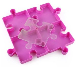 Macro view of interlocking purple puzzle storage trays with a clear lid for accessories