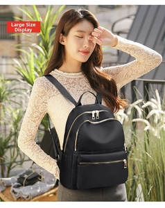 Large size Oxford cloth backpack shown on model with gold zippers and stylish black finish