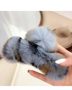 Close-up of soft gray and brown rabbit fur claw clip for women's winter hairstyle