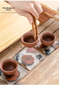 Detail of square resin wood coaster with natural grain texture and ceramic teacup