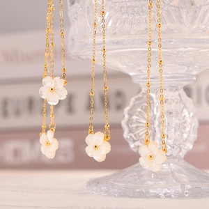 Elegant gold bead chain necklace featuring white shell flower pendants for women