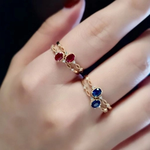 Elegant gold plated lace rings with oval blue and red gemstones in a stacked design