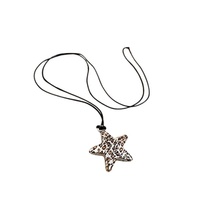 Leopard print star pendant necklace with black wax rope cord on white background