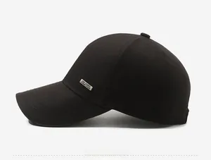 Side view of black cotton baseball cap with silver metal Hat Sports logo and stitched brim