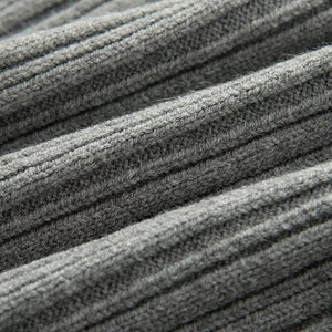 Macro view of grey ribbed knit fabric showing soft texture and high-quality wool fibers