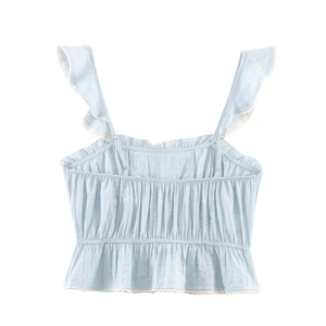 Detail of light blue camisole featuring ruffled straps, smocked waist, and lace hem trim
