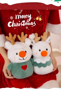 Close-up of plush reindeer and Christmas tree dolls with soft velvet and embroidery