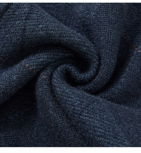Macro shot of high-quality navy blue knitted fabric with orange fiber details