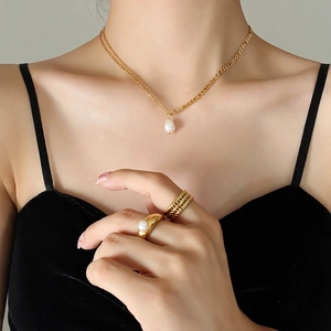 Double layered gold chain necklace with pearl pendant and matching gold rings set
