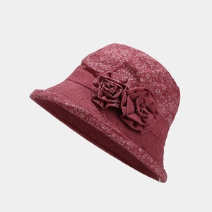 Detail of dark red elderly women sun hat with floral texture and fabric rose decor