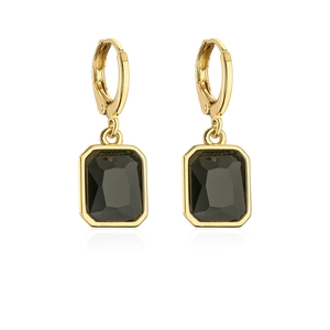 Detail of gold-plated drop earrings featuring a black rectangular zircon and sleek finish
