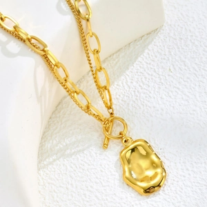 Double-layered gold titanium necklace with irregular pendant and OT toggle clasp