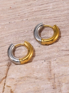 Detail of two-tone gold and silver plated stainless steel hoop earrings with high polish