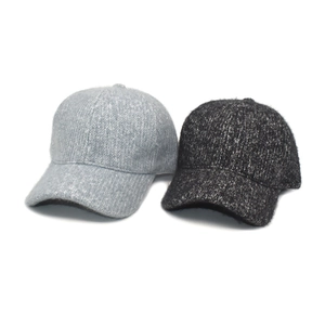 Detailed texture view of thick warm knit baseball caps in light and dark grey for winter