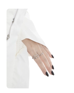 Detailed view of layered S925 sterling silver rings with irregular organic lines on finger
