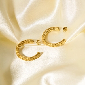 Minimalist 18k gold plated stainless steel twisted C-shape hoop earrings on silk