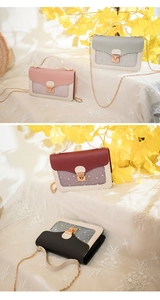 Detail view of mini shoulder bags with sequin stars, metal lock, and chain strap