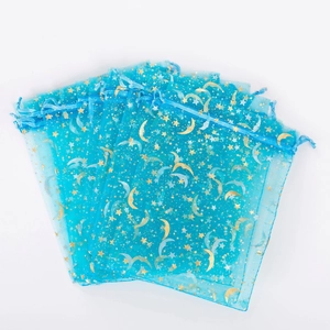 Blue organza gift bags with gold foil star and moon patterns for jewelry storage