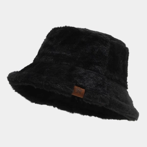 Close-up of black plush bucket hat with a leather snowflake label for winter warmth