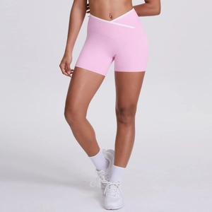 Detail of cross V-waist yoga shorts with contrast white trim in pink high-stretch fabric